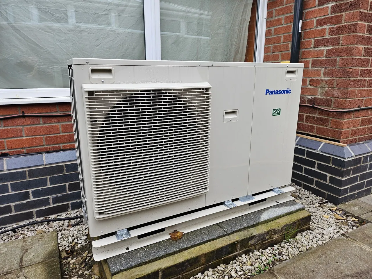 Air source heat pump installed outside a property.