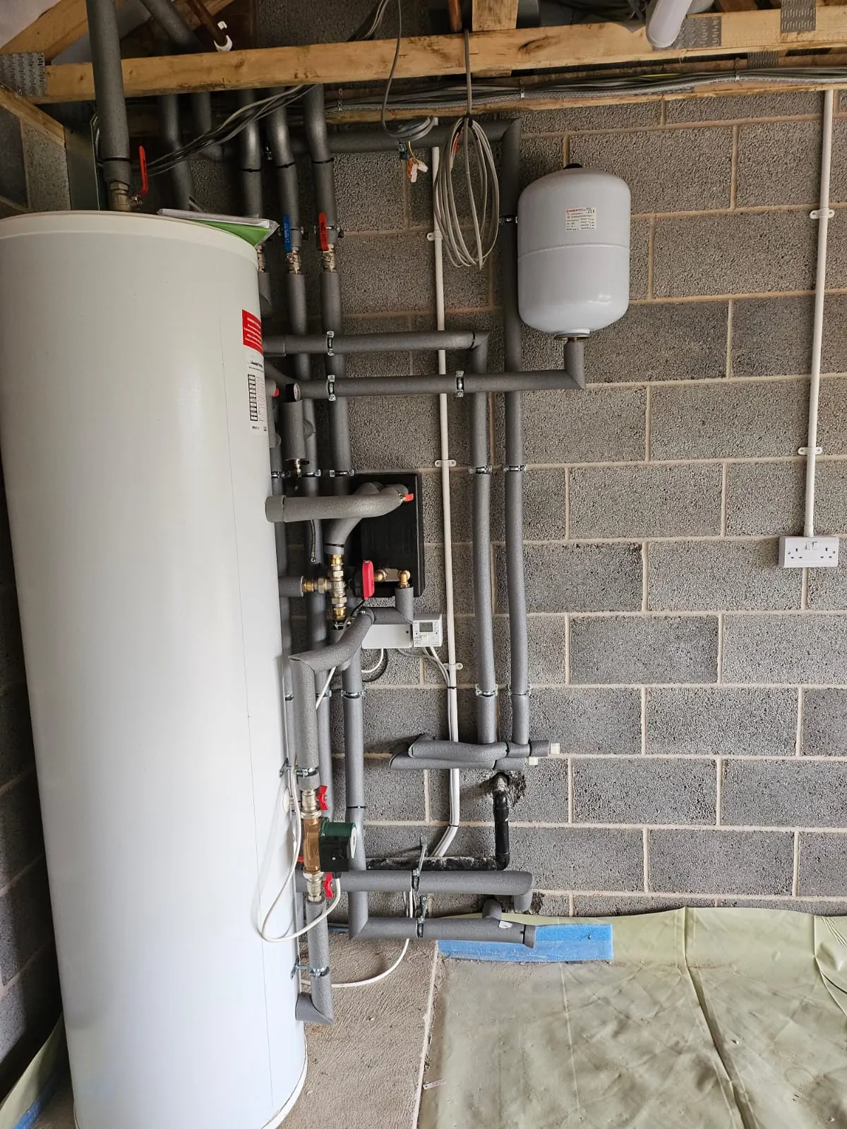 Plant room pipework and cylinder equipment for renewable heating servicing.