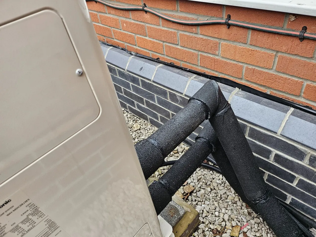 Pre-insulated primary pipework for heat pump installation.